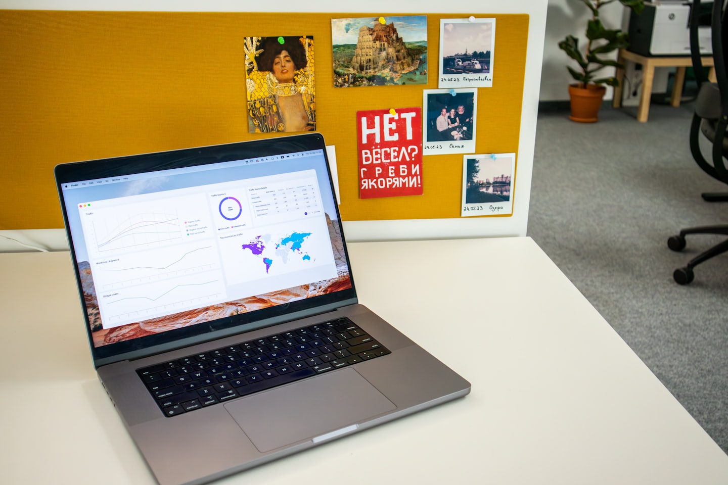 Silver laptop showing data analytics dashboard on a white desk.
