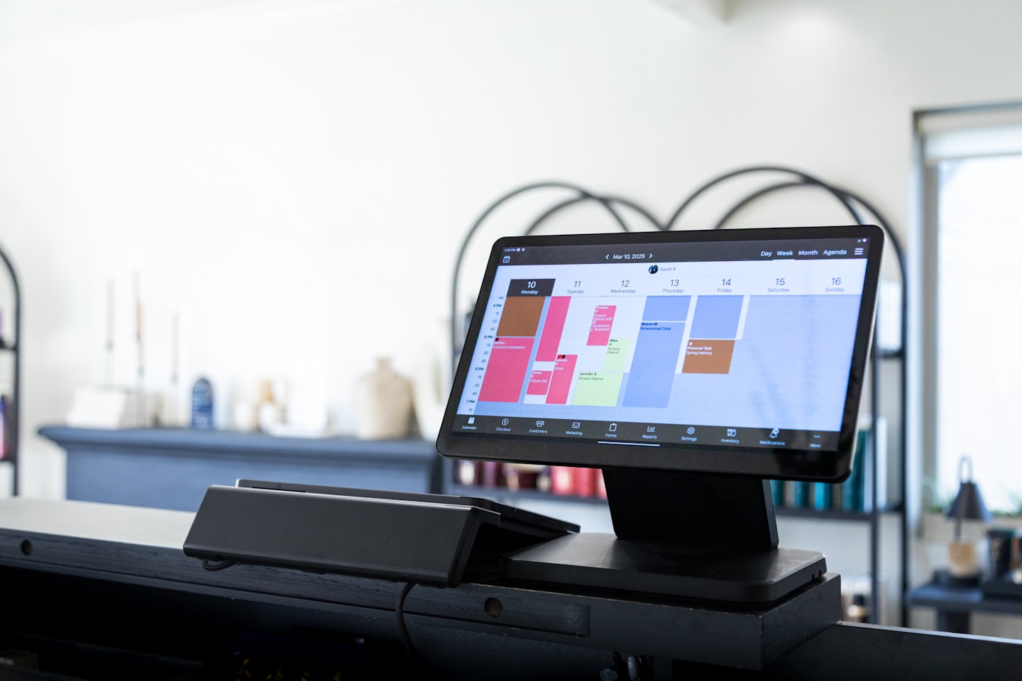 Digital tablet displaying a weekly business scheduling calendar.